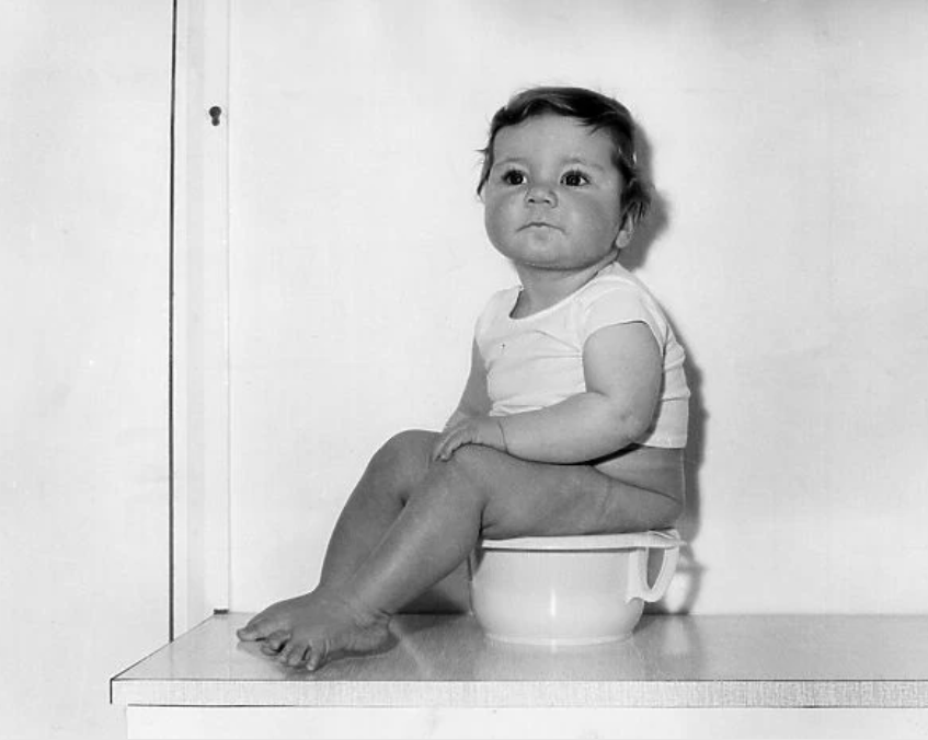 boy or girl on potty black and white image. When is the best time to start potty training.