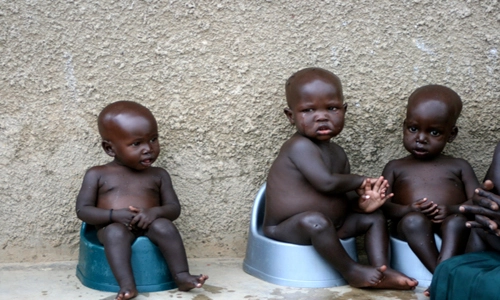 children-potty-training-africa three African boys each sitting on a potty